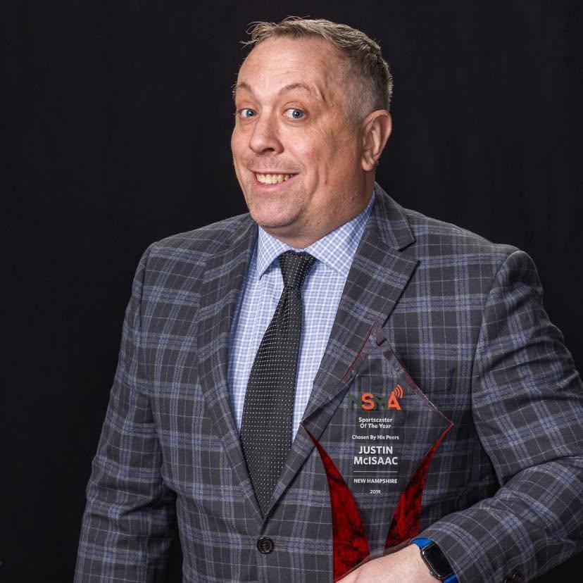 Justin McIsaac holding an award